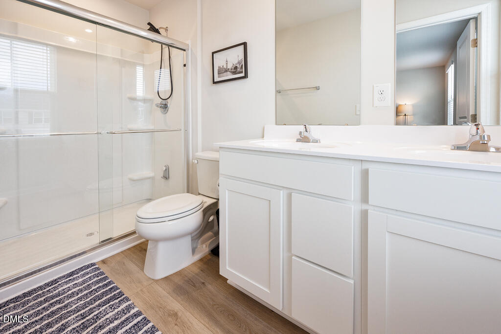 4468 Captain Falls Drive Raleigh, NC 27610 - Photo 21 of 36 a bathroom with a sink toilet and shower