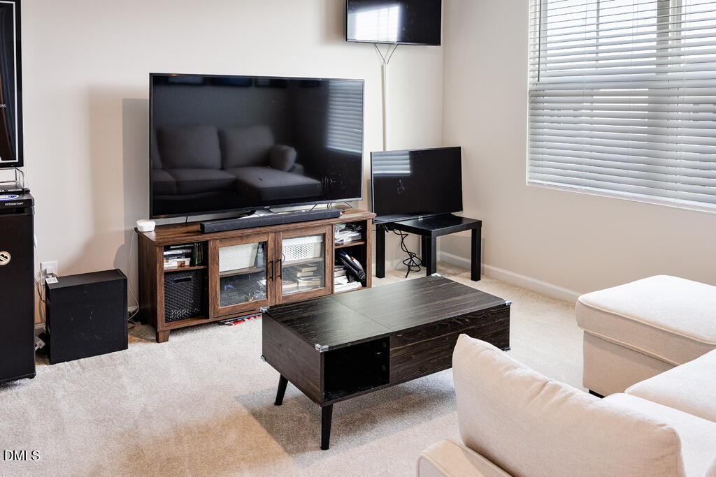 4468 Captain Falls Drive Raleigh, NC 27610 - Photo 23 of 36 a living room with furniture and a flat screen tv