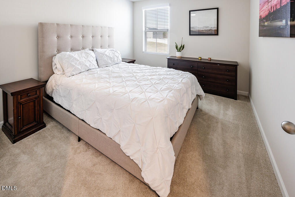 4468 Captain Falls Drive Raleigh, NC 27610 - Photo 25 of 36 a bed sitting in a bedroom and night stand