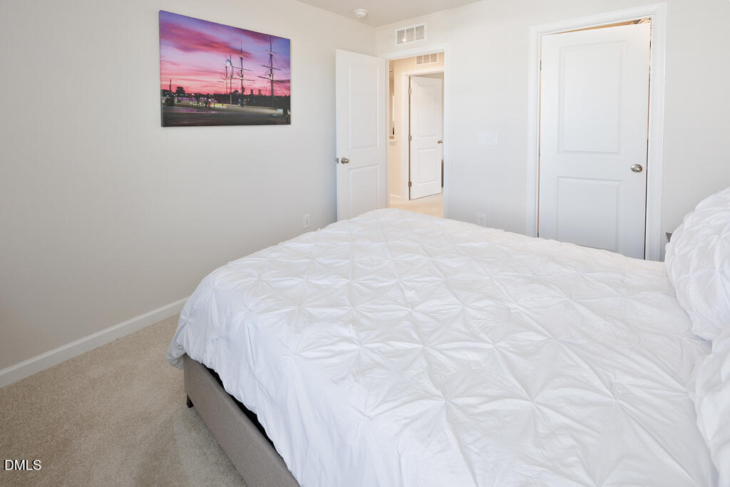 4468 Captain Falls Drive Raleigh, NC 27610 - Photo 26 of 36 a bedroom with a bed and wall painting