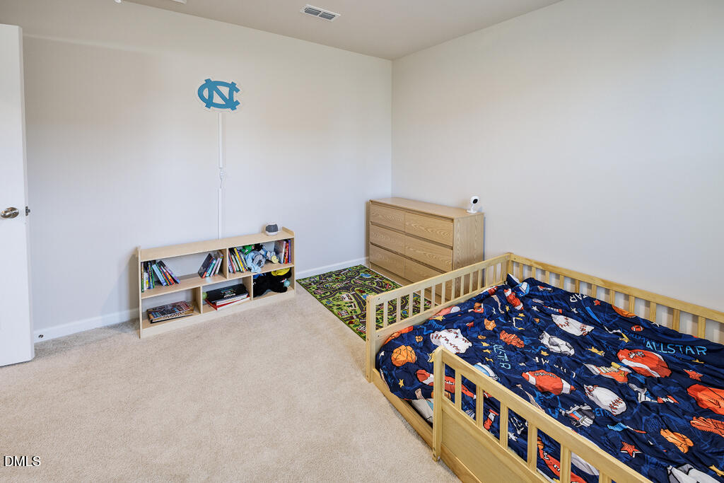4468 Captain Falls Drive Raleigh, NC 27610 - Photo 27 of 36 a room with toys and wooden floor