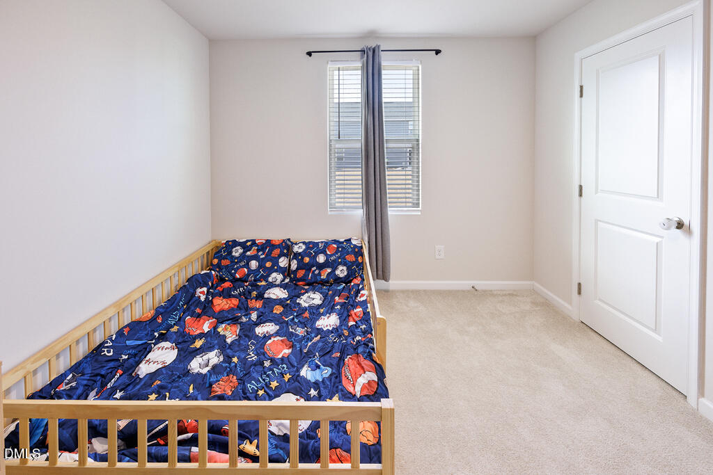 4468 Captain Falls Drive Raleigh, NC 27610 - Photo 28 of 36 a bedroom with a large window