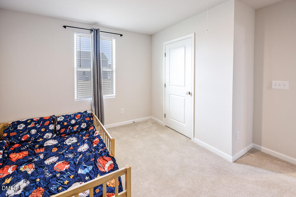 4468 Captain Falls Drive Raleigh, NC 27610 - Photo 29 of 36 a bedroom with natural light and a window