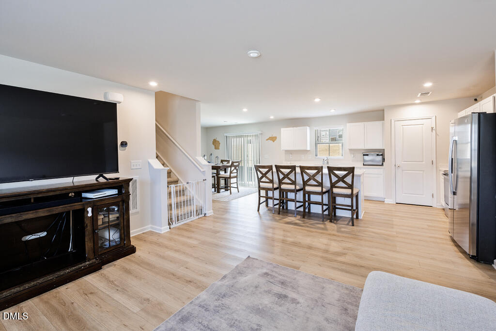 4468 Captain Falls Drive Raleigh, NC 27610 - Photo 3 of 36 a view of kitchen with furniture and flat screen tv