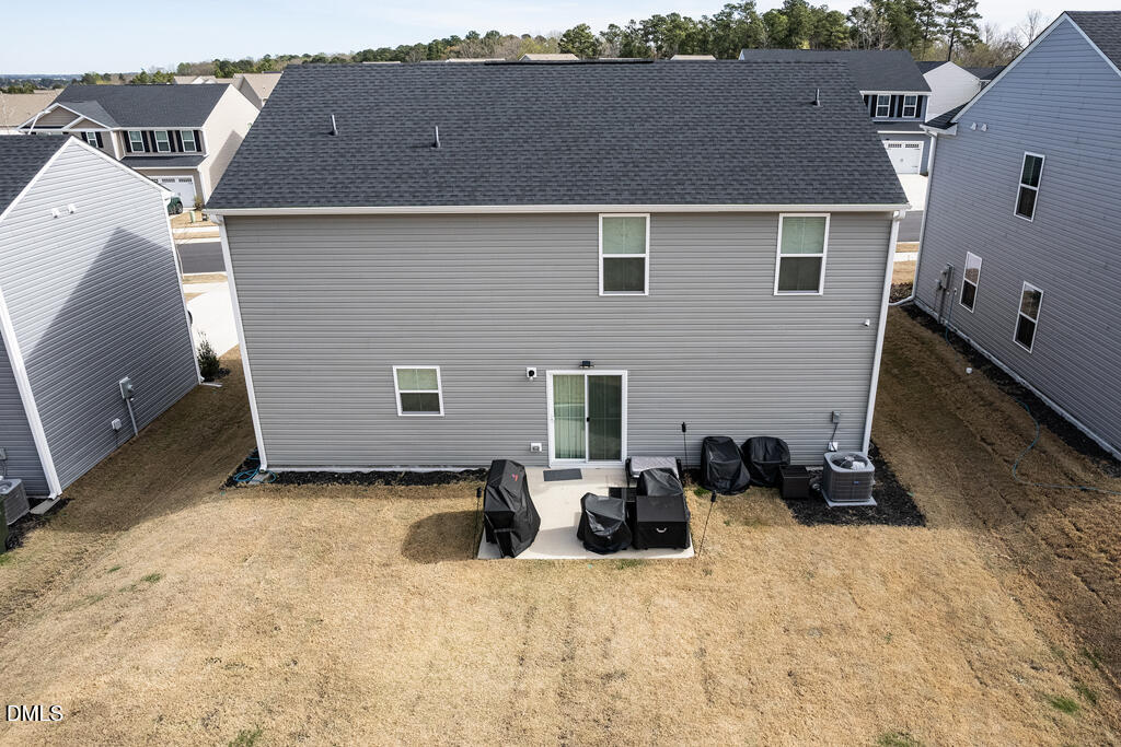 4468 Captain Falls Drive Raleigh, NC 27610 - Photo 33 of 36 a backyard of a house with table and chairs