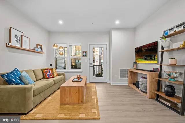 a living room with fireplace furniture and a flat screen tv