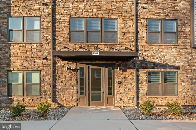 a view of a brick building with a door and windows