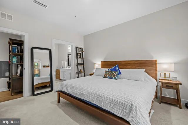 a bathroom with a double vanity sink a toilet and mirror