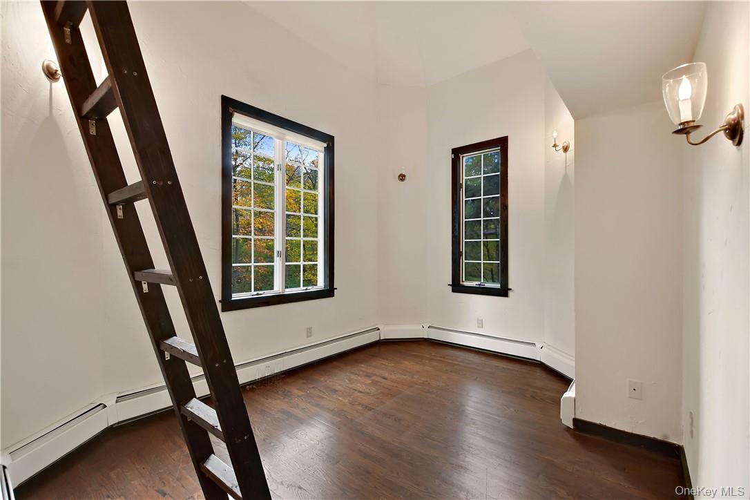 160 Long Ridge Road Bedford, NY 10506 - Photo 16 of 25 a view of an empty room with wooden floor and a window