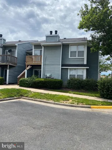 a view of a house with a swimming pool and a large tree