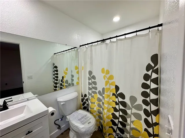 a white toilet sitting next to a bathroom sink