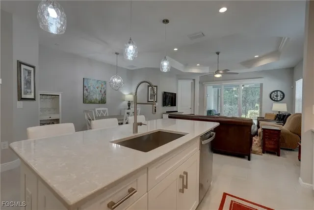 a living room with furniture and a ceiling fan