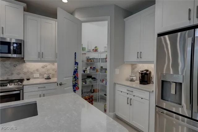 a room with a bed and a painting on the wall