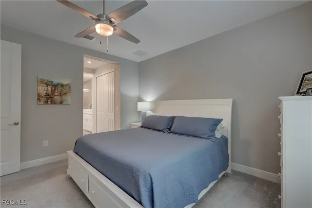 a bedroom with a bed mirror and a large window