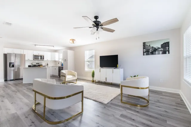 a kitchen with stainless steel appliances granite countertop a sink a stove a microwave a refrigerator and cabinets