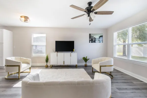 a white bed sitting in a bedroom next to a cabinet