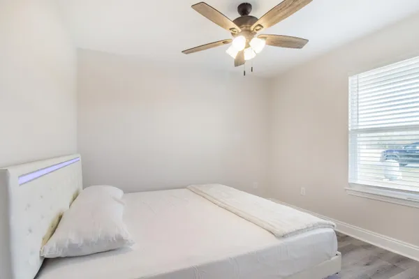 a bed sitting in a bedroom next to a window