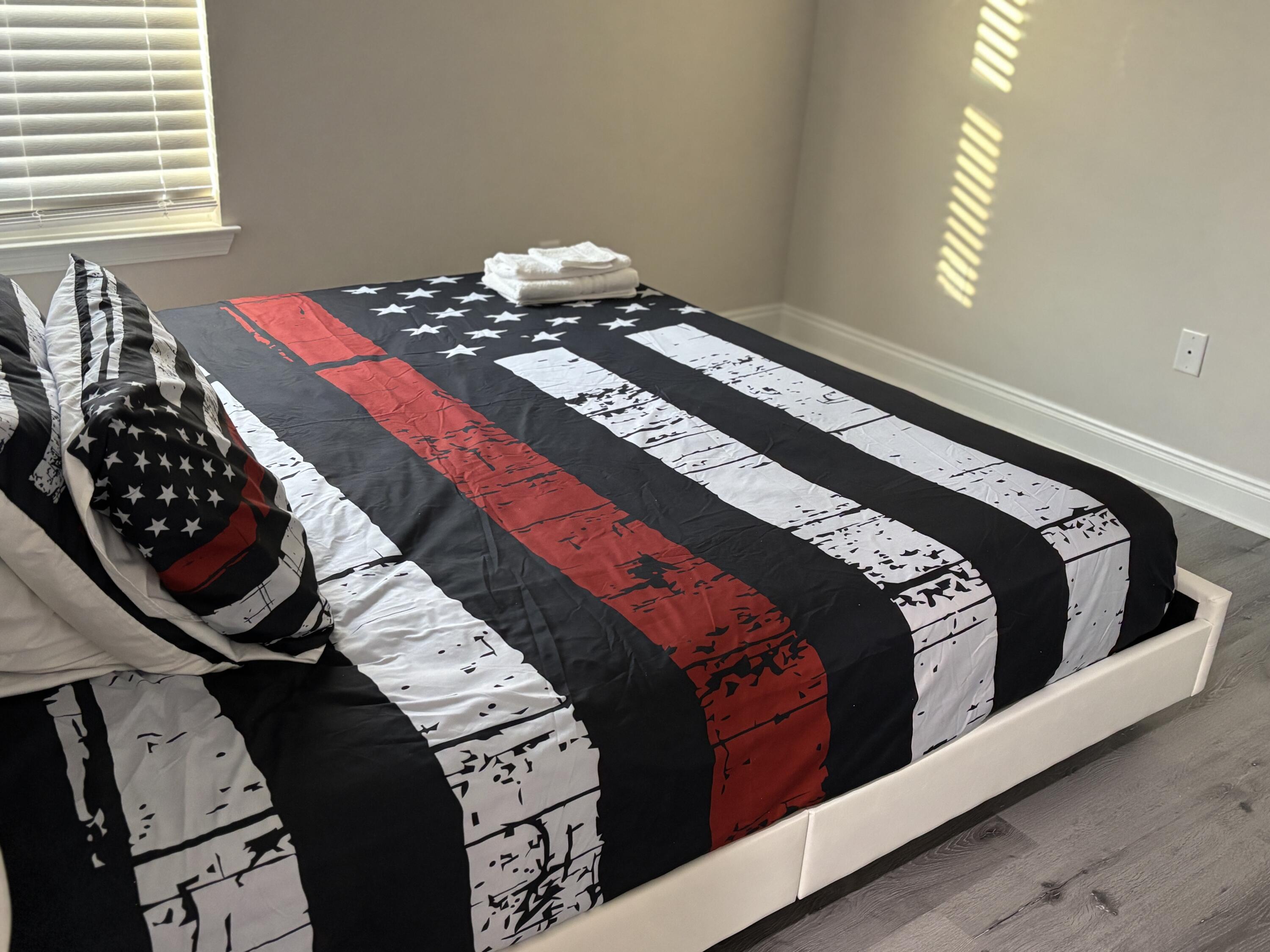 5374 Highview Drive Crestview, FL 32539 - Photo 9 of 12 a bed sitting in a bedroom next to a window