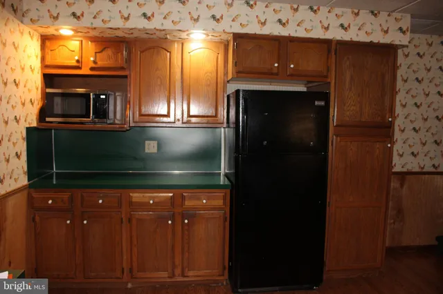a living room with a mirror and wooden floor