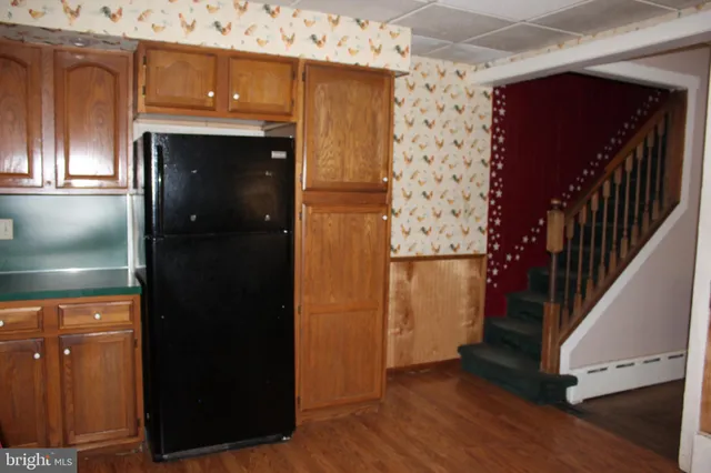 a large bed sitting in a room next to a window