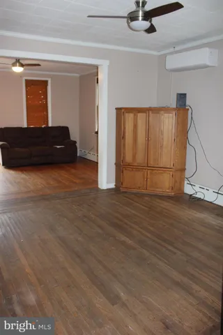 view of a room with a chandelier fan and windows