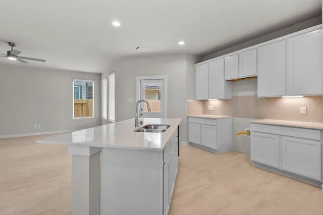 a kitchen with a sink stove and cabinets
