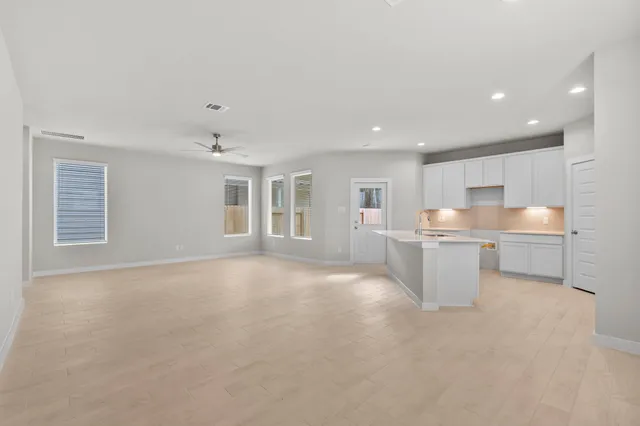 a view of a kitchen with a sink and a window