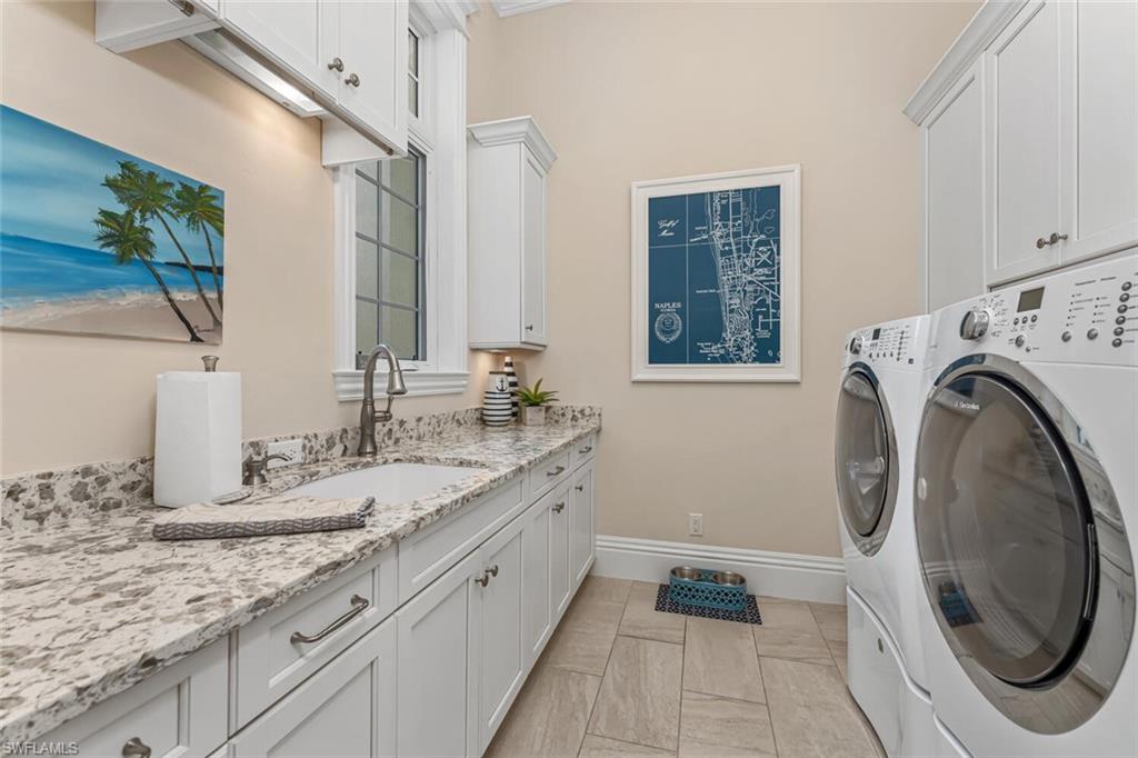 2301 Crayton Road Naples, FL 34103 - Photo 14 of 32 a bathroom with a granite countertop double vanity and a mirror