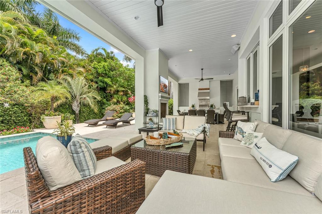 2301 Crayton Road Naples, FL 34103 - Photo 23 of 32 a living room with furniture and a large window
