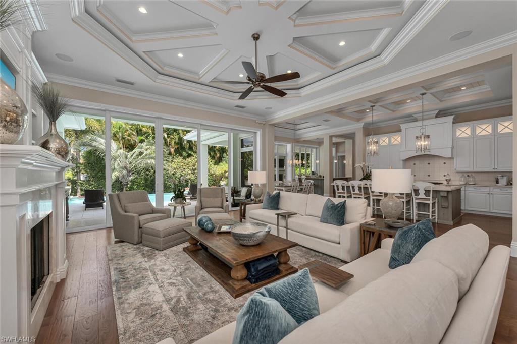 2301 Crayton Road Naples, FL 34103 - Photo 3 of 32 a living room with furniture fireplace and a large window
