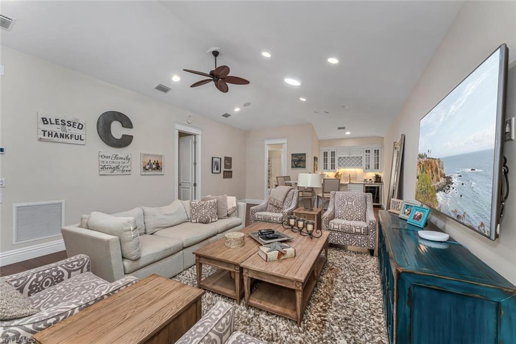 2301 Crayton Road Naples, FL 34103 - Photo 10 of 32 a living room with furniture and a wooden floor