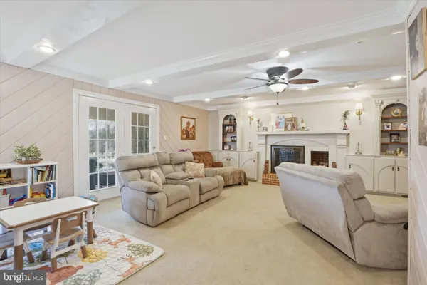 a living room with furniture fireplace and a window