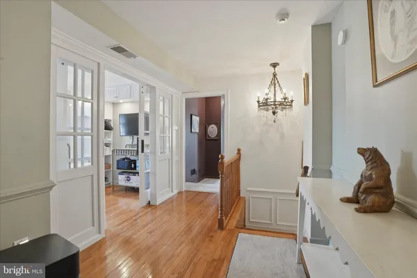 a view of a room with wooden floor and furniture