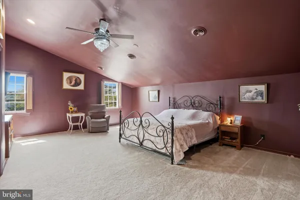 a spacious bedroom with a bed and a chandelier