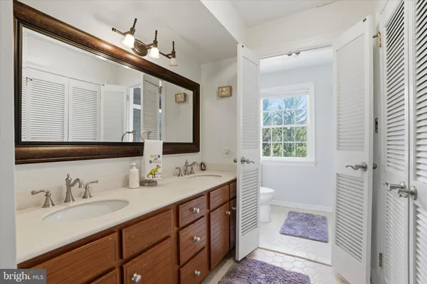 a bathroom with a double vanity sink and a mirror