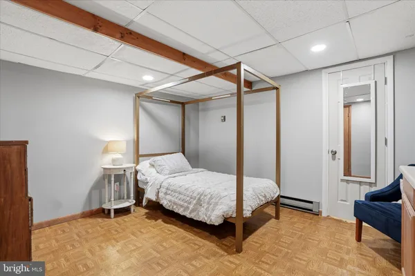 a bedroom with a bed and a chair