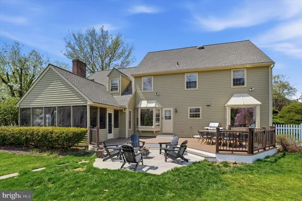 a view of a house with backyard porch and sitting area
