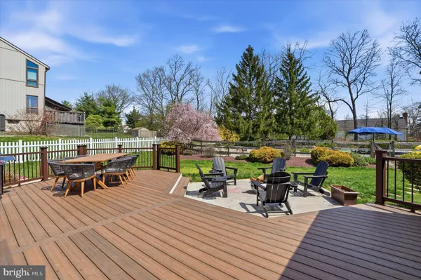 a view of a deck with table and chairs with wooden floor and fence