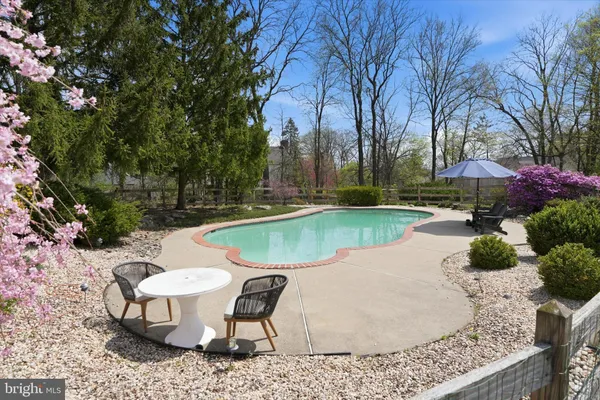 a view of a backyard with swimming pool