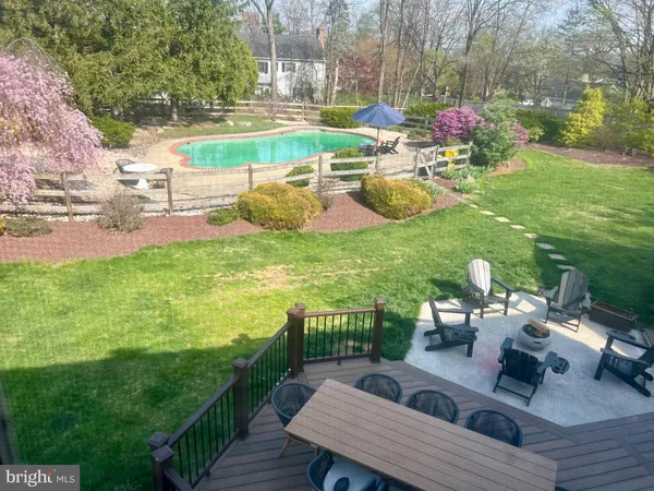 a view of a chairs and table in patio with a yard