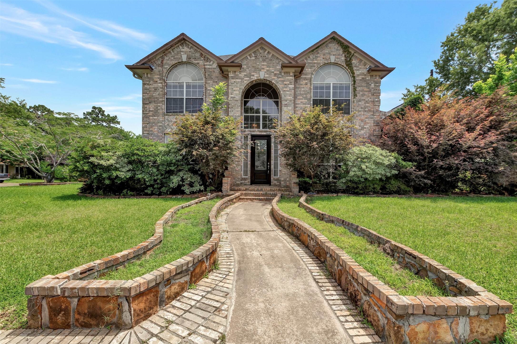 a front view of a house with garden