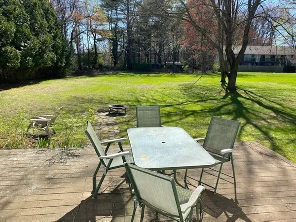 a view of a chairs and table in patio