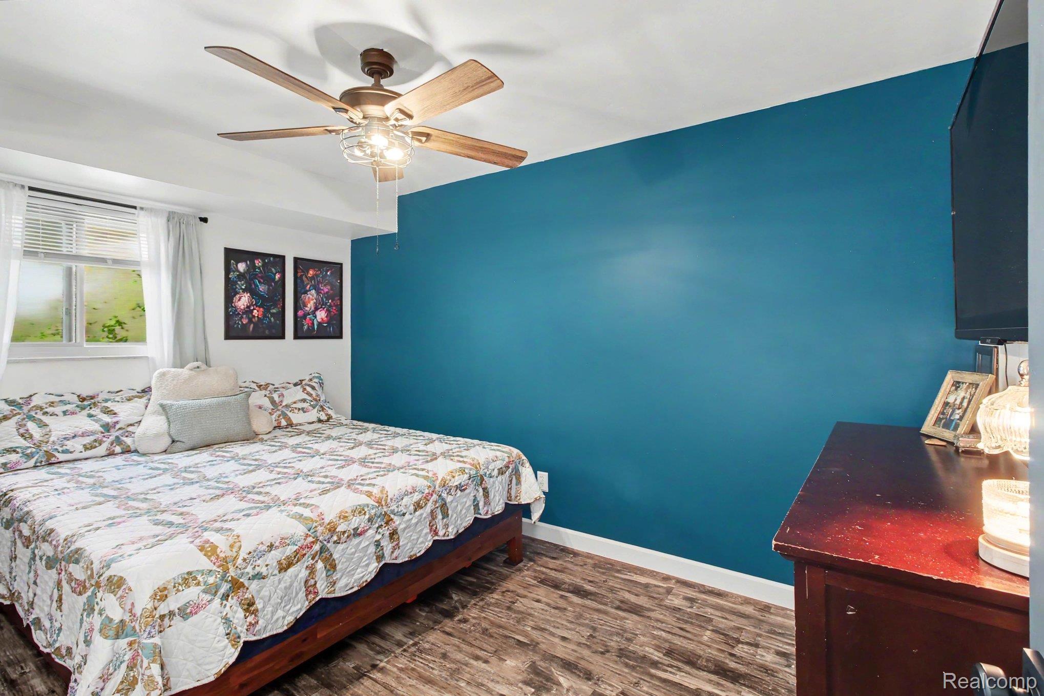 4623 West Lovejoy Road Byron, MI 48418 - Photo 12 of 21 Bedroom featuring dark wood-style flooring and ceiling fan