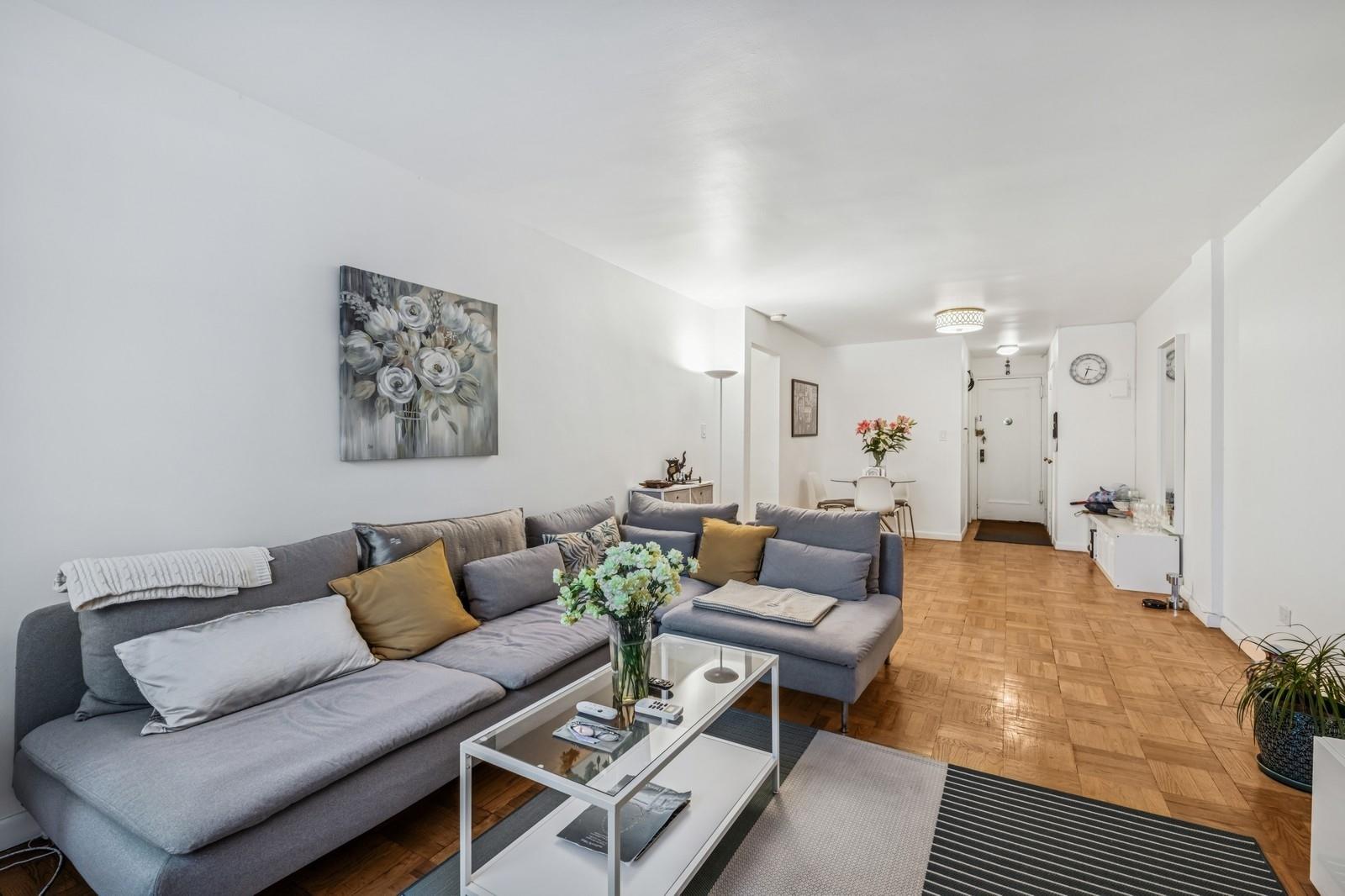 a living room with furniture and a rug