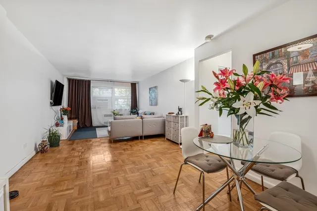 a living room with furniture and flowers