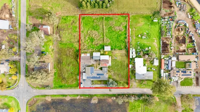 a front view of a house with a yard table and chairs