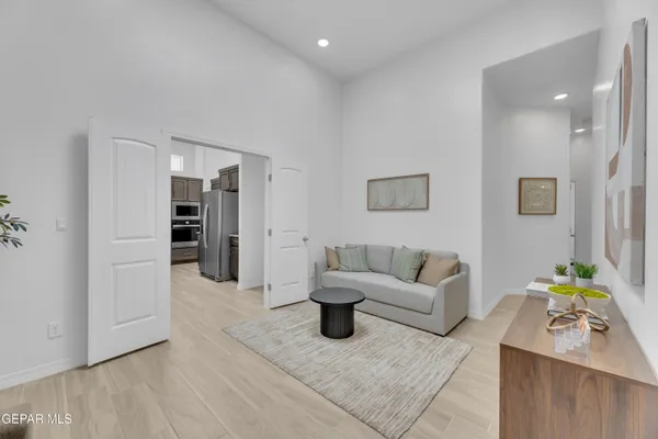a living room with furniture and wooden floor