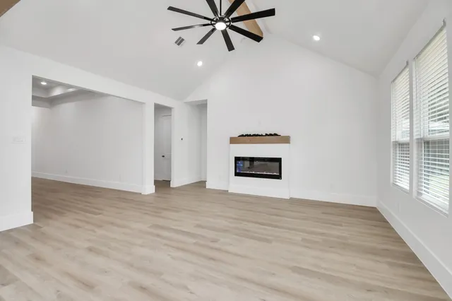 a spacious bathroom with a double vanity sink and mirror with shower