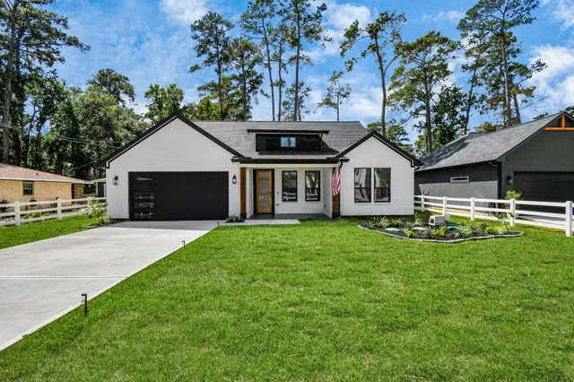 a front view of a house with a garden and yard