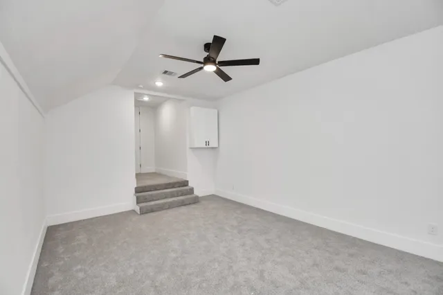a view of an empty room with a ceiling fan